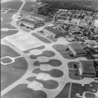 Aerial photograph of part of a military airfield with aircraft hangers.