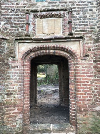 Brick gatehouse with view through the open gateway.