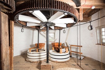 Interior of Moulton Windmill, a Grade I listed tower mill and adjoining granary in Lincolnshire, showing its internal machinery that survives intact and most in working order. It was built around 1822 by the architect Robert King and is considered to be an outstanding example of a tower mill, with local and national importance.