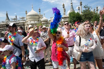 Colourfully dressed people celebrating Pride