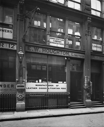 The lower front of 13 Edmund Place, showing signs for occupants of the premises E W Houghton Limited leather good manufacturers and John B Stetson hat manufacturers.