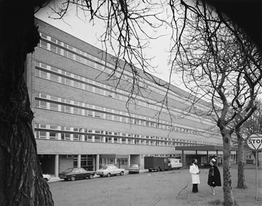 A black and white image of St Thomas Hospital with a nurse and doctor in uniform in the foreground.