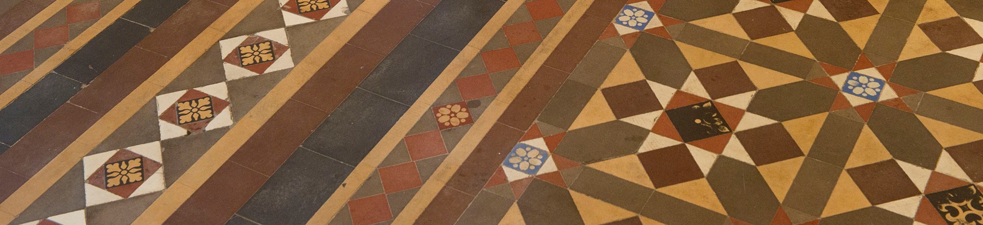 Image of historic floor tiles set out in an intricate pattern.
