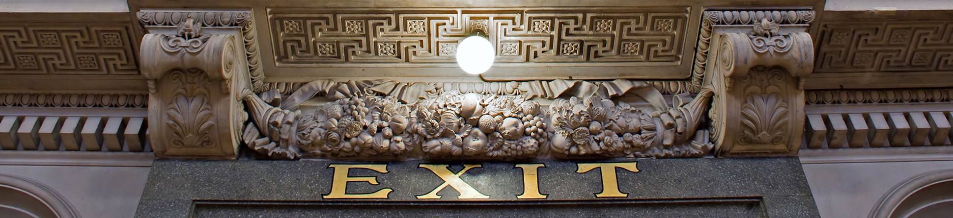 EXIT sign in gold letters above a doorway