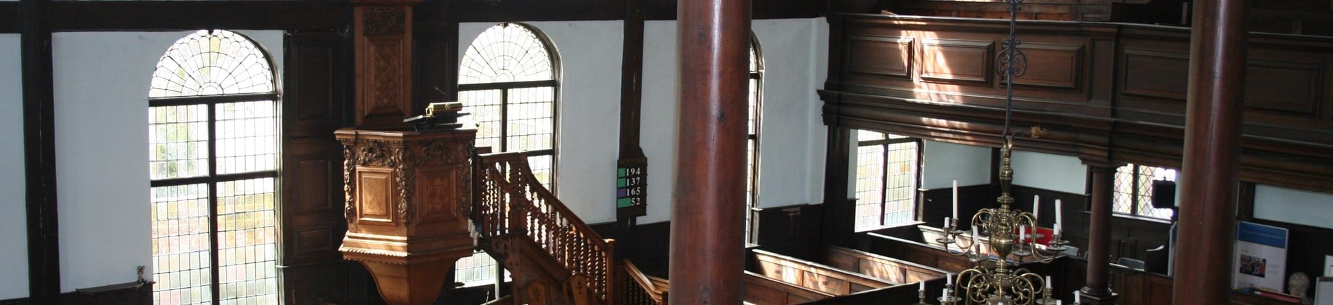 The interior of the Unitarian Meeting House in Ipswich is classically grand with wooden box pews and a beautifully carved pulpit.