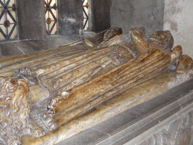 Canopied tomb in the south choir aisle with two life-sized alabaster effigies of a medieval merchant and his wife.