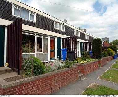 Front view of 5M houses in Sheffield with low brick garden walls and neat flower beds.