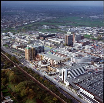 Colour aerial photograph from an oblique angle, showing the Eastgate Centre during construction and the surrounding area.