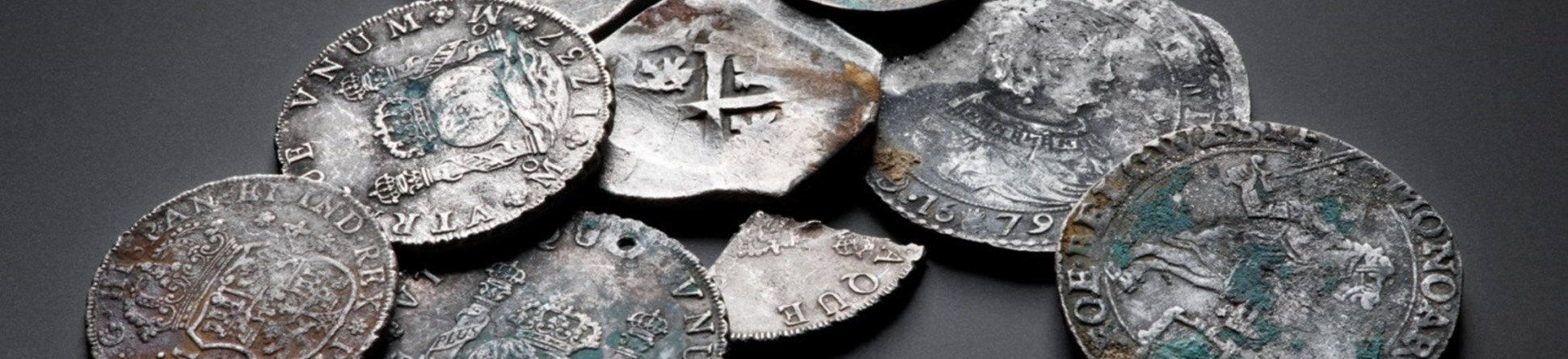 A selection of silver coins, including some snipped fragments.