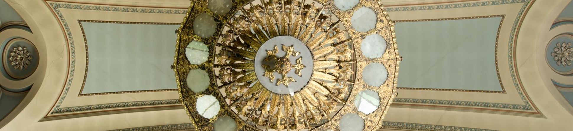 a church ceiling with a round light fitting in the centre