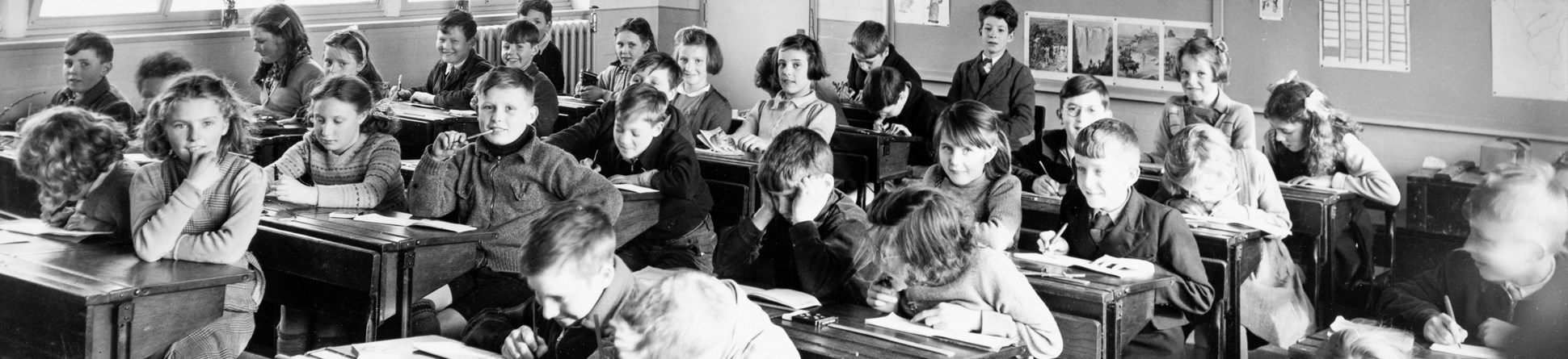 Black and white photo of children studying at their desks in a classroom at Cleator Moor School