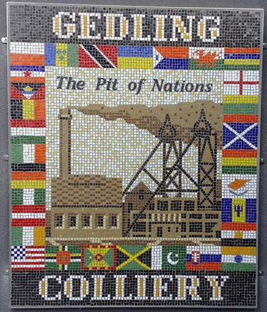 The 'Pit of Nations Mosaic' showing Gedling Colliery surrounded by flags of the nations of its diverse workforce.