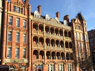 Red brick building with covered balcony areas