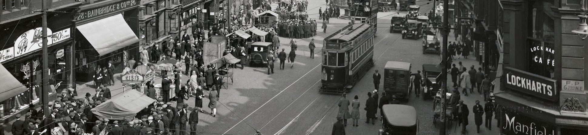 Black and white photo of a busy street scene 1925-1930.