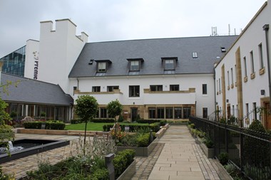Image of the Cathedral Court showing new buildings housing accommodation, a garden area for those living there and the link building between the new space and the Cathedral.