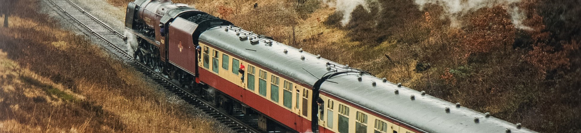 A train on the East Lancashire Light Railway emitting a plume of smoke.