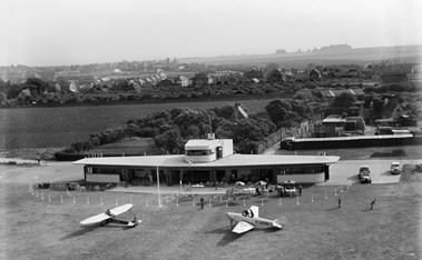 Aerial view of aerodrome with two small planes parked outside