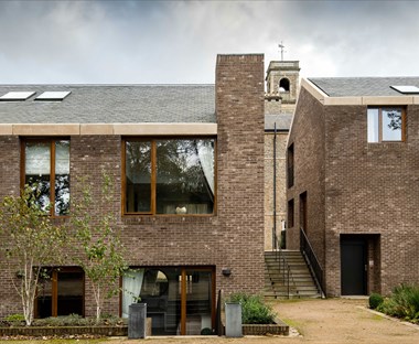 Modern brick mews style housing with stairs between the blocks.
