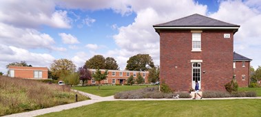 Brick-built housing at a redeveloped former Royal Air Force site with refurbished barrack blocks.