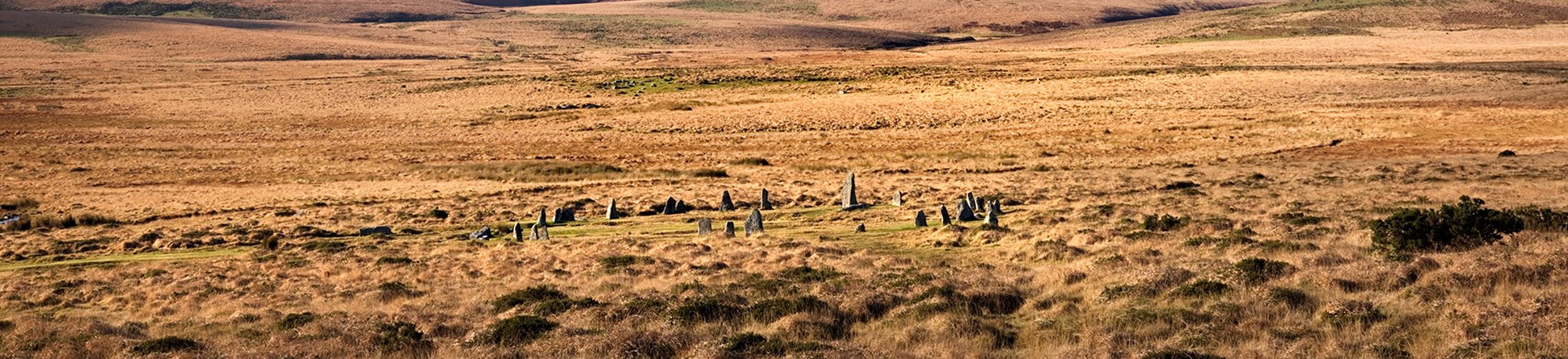 A stone circle in a wide open landscape.