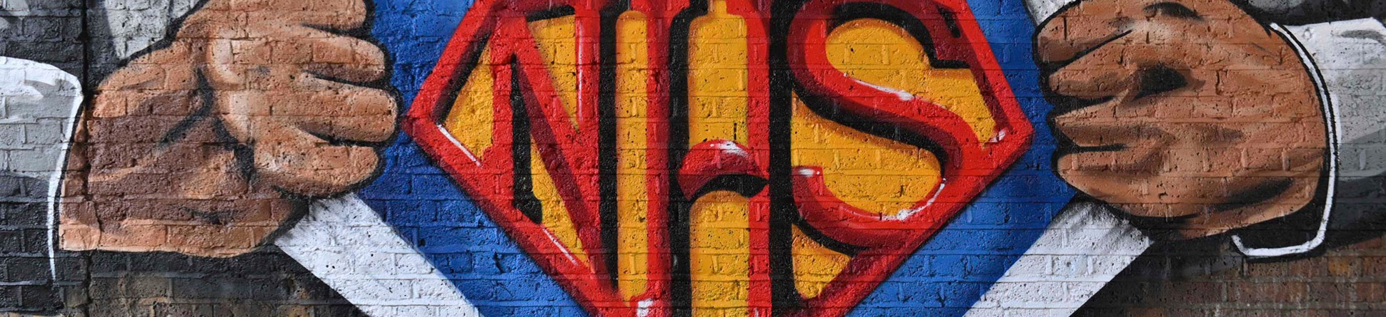 Work by a graffiti artist depicting the torso of a superman-style character pulling back his shirt to reveal a costume bearing the letters ‘NHS’.