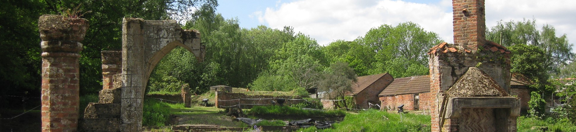 View of a green landscape with ruined brick structures