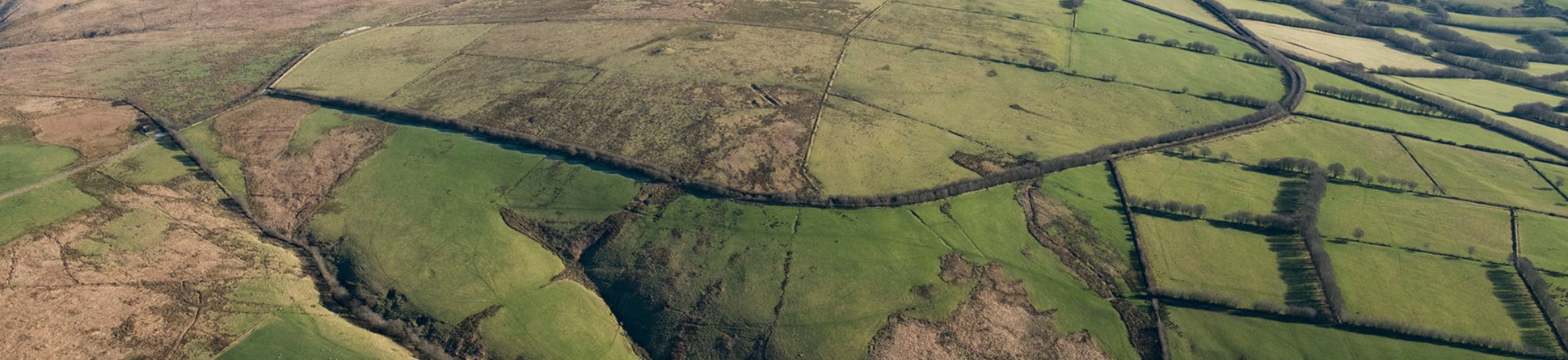 An aerial view of a hilly moorland landscape.