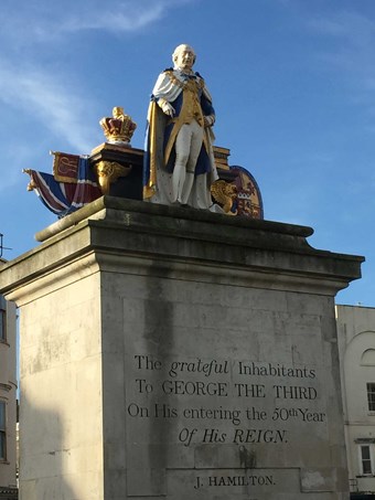 Statue of King George III on a plinth which has the words 'The grateful inhabitants to George the Third on his entering the 50th year of his reign. J Hamilton.' inscribed on it