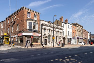 Street of shops and pedestrians in Wakefield.