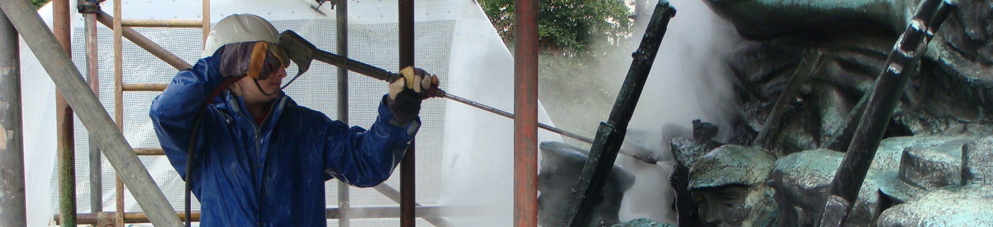 Image showing the cleaning of bronze statuary on a a war memorial with super-heated water.