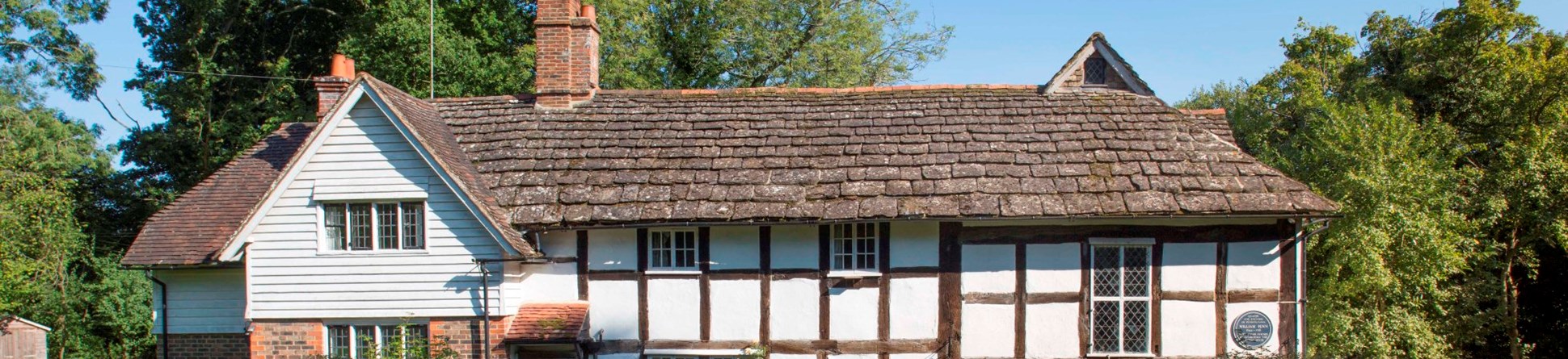 Blue Idol Quaker Meeting House, West Sussex, view from west showing timber-framed soulth range and weather-boarded west-facing gable above later brick bay.