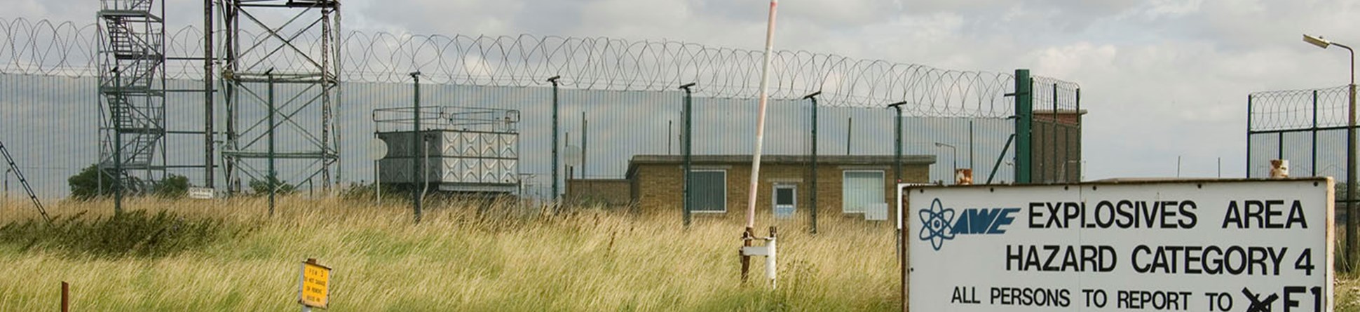 Atomic Weapons Establishment, Foulness, Essex, explosives area warning sign and security fence.