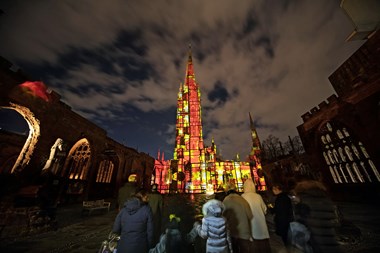 A group watching the light projections onto cathedral building.