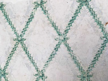 A historic wallpaper featuring a floral diamond pattern. The green pigment contains arsenic.