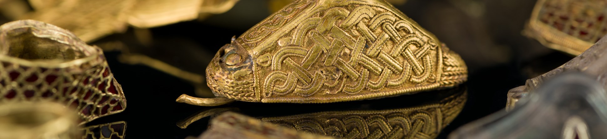 Detail of a group of decorated gold objects.