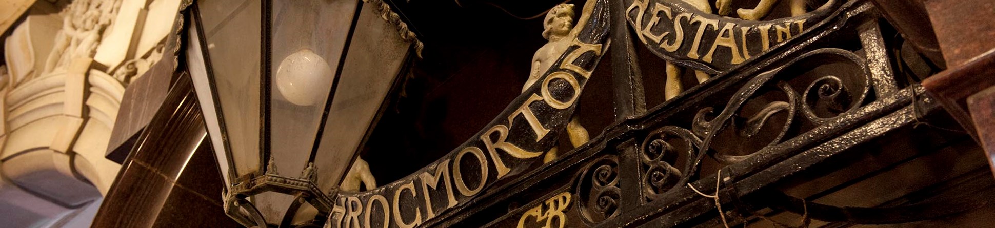 Detail of the signage for J Lyon's Throgmorton Restaurant and street lamp