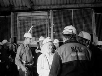 The Queen meets 'onsetter' Stan Wood after stepping from the cage at the pit bottom, 600 yards underground during her visit with Prince Philip (background) to Silverwood Colliery, near Rotherham, 30 July 1975 © PA Images / Alamy Stock Photo.