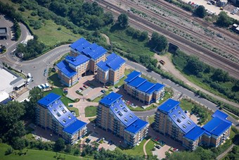 Colour aerial photograph showing modern buildings with blue rooves.