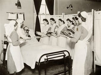 A nursing sister giving a class of nurses a demonstration in the ward on the B.L.B. oxygen mask