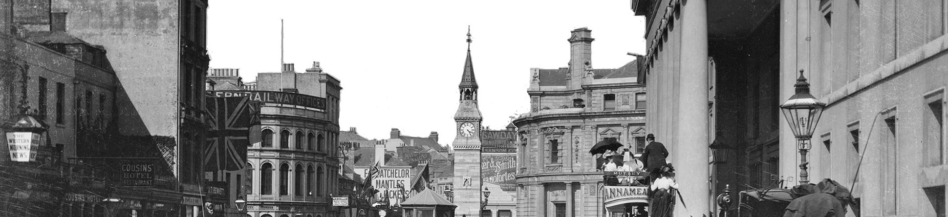 Black and white archive photograph of a busy street scene.
