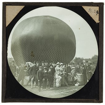 A crowd posed in front of a partially-inflated balloon