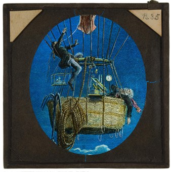 A hand-coloured slide showing an engraving of James Glaisher and Henry Coxwell in the basket of a gas balloon during their ascent to c.10000 feet in 1862