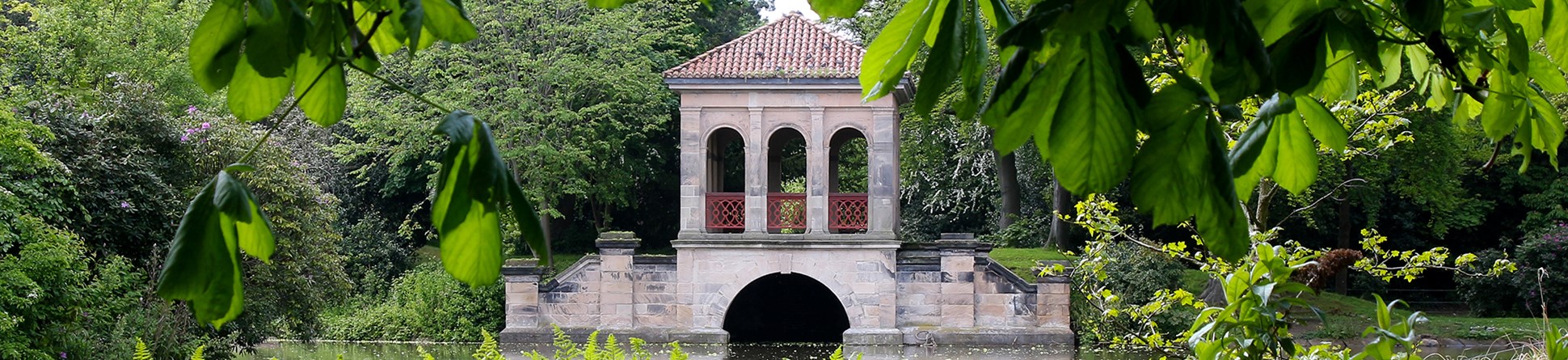 View across the lake to the Roman Boathouse in Birkenhead Park, The Wirral