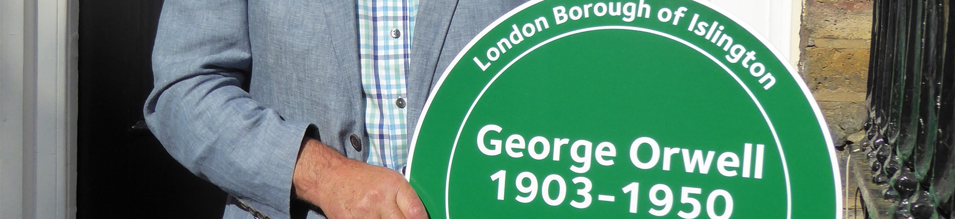 Richard Blair is Orwell's son, here holding a plaque erected on the family home in 2016.