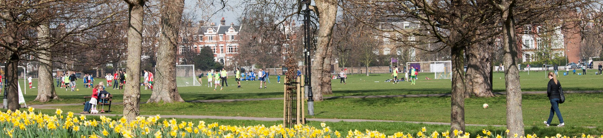 Visitors playing football at Clapham Common