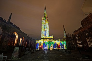 Stained glass window projected onto cathedral building
