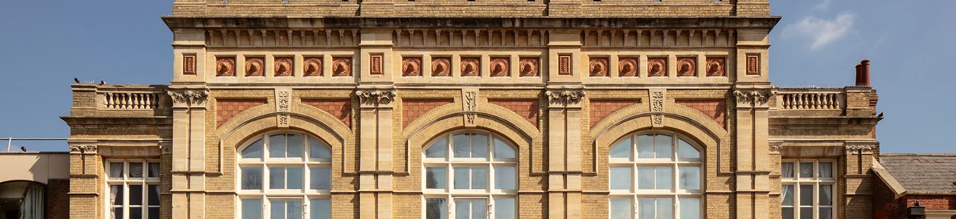 Bedford Corn Exchange is a five-bay, two-storey building. The roof has a slate covering and the walls are constructed of white brick with Bath stone cornices and pennant stone dressings.


