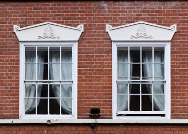 Two sash windows in a red brick building.
