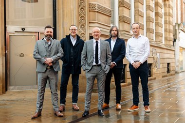 Photo of five men in smart clothing posing in front of 55 Whitefriargate.