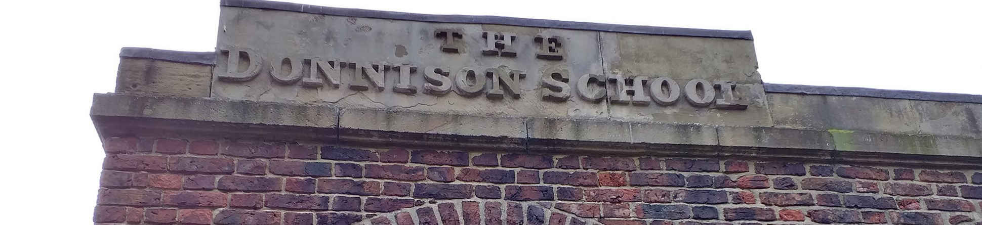 THE DONNISON SCHOOL in top panel above a door in low-relief letters
